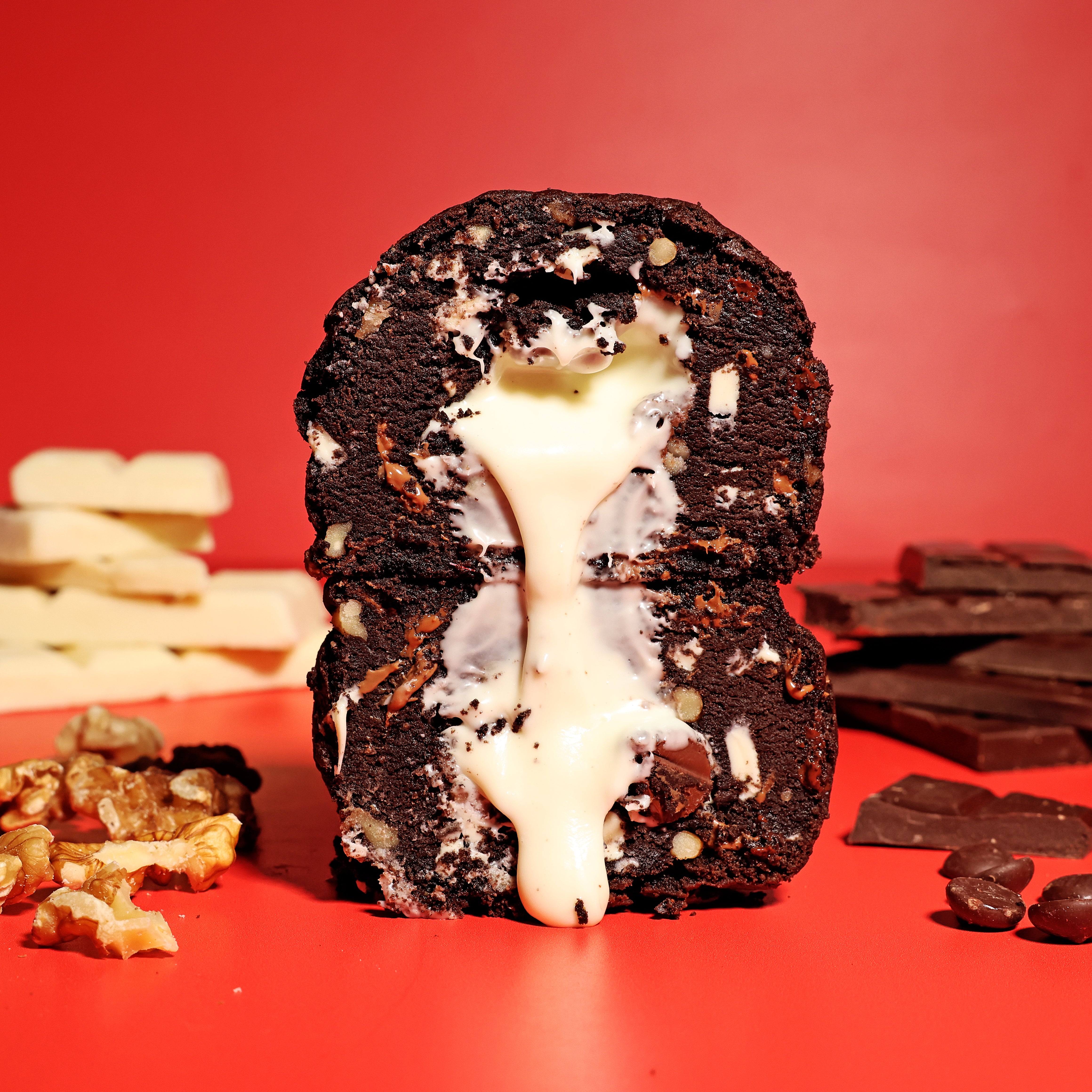 Chocolate dessert with white cream filling on a red background